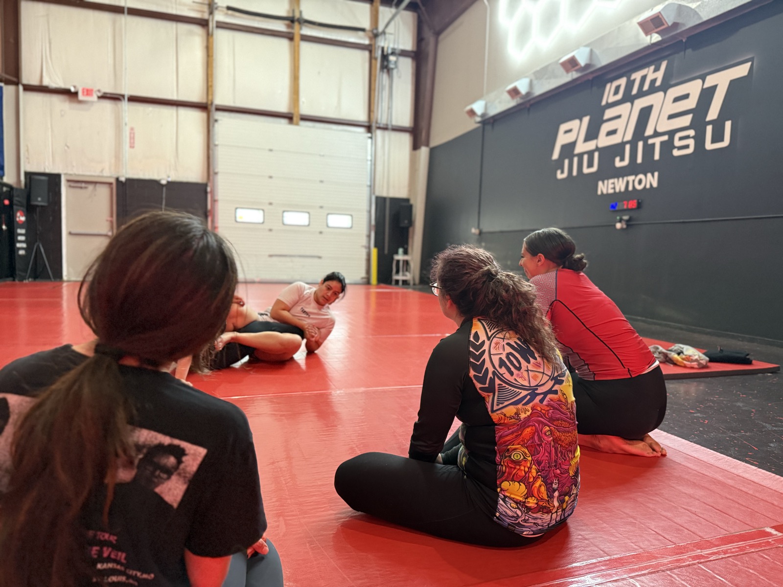 Women drilling no-gi jiu-jitsu